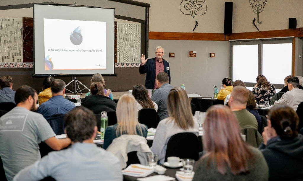 Mark Bunting presenting the OPEN FLAME techniques with coloured flames on screen